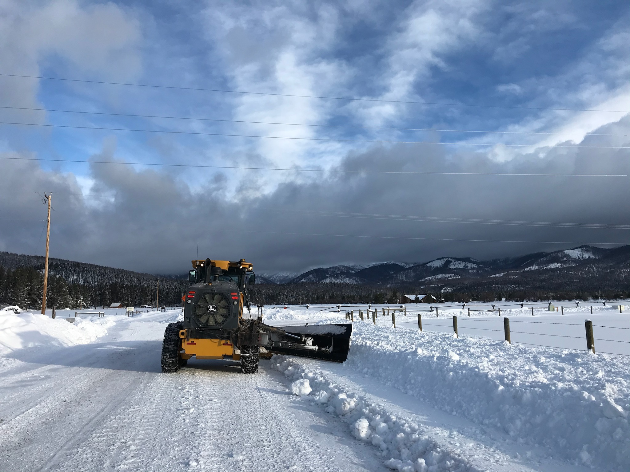 Snow plow on a rural road in winter